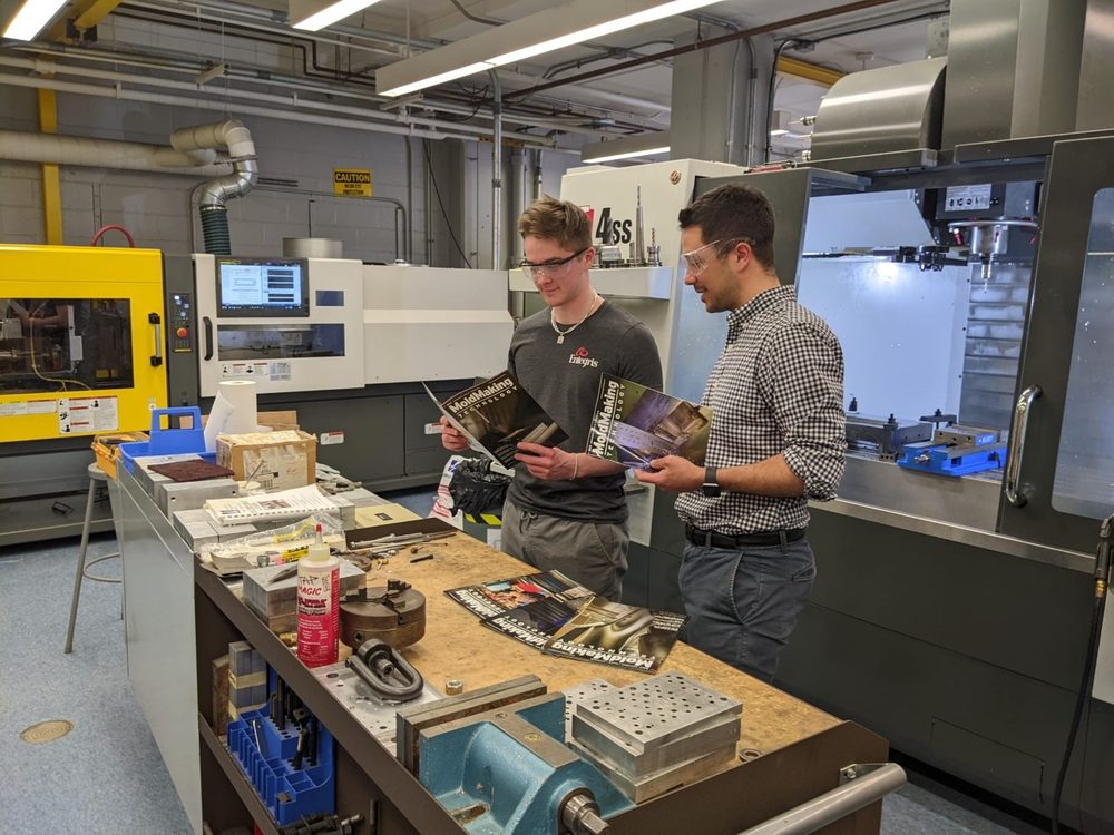 Students reviewing Mold Making Technology magazine in the plastics engineering lab